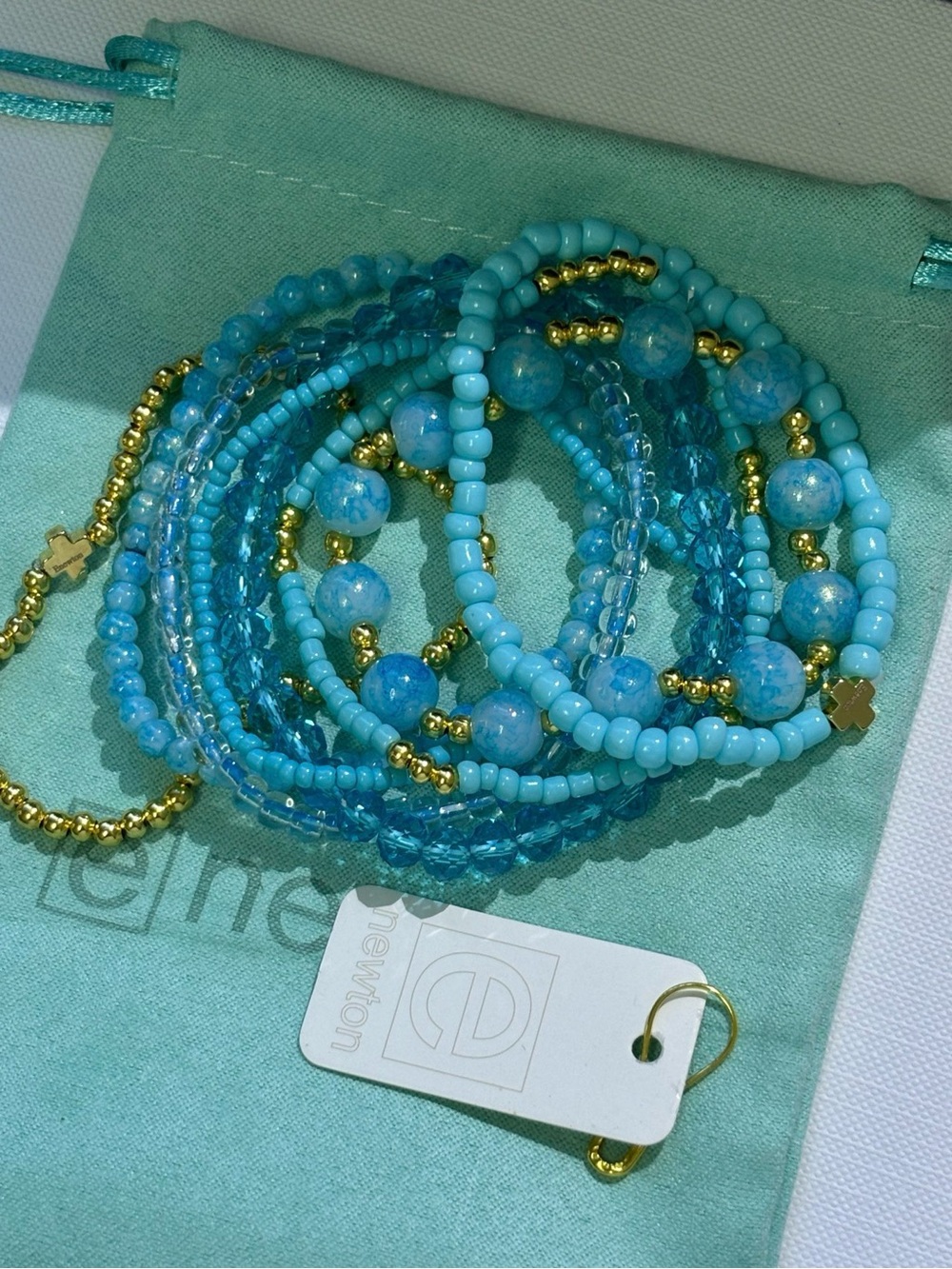 enewton 8-Piece Stackable Beaded
Bracelet Set Ocean Blue Gold Cross Charm